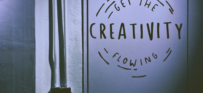 Get the Creativity Flowing written on a wall encouraging a creative mindset and personal growth.